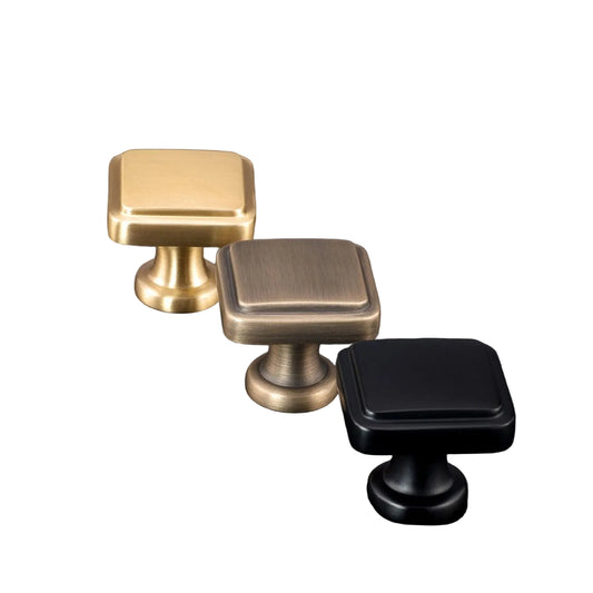 Three cabinet knobs in satin brass, English bronze, and powder coated black on a dark background with AceLine branding.