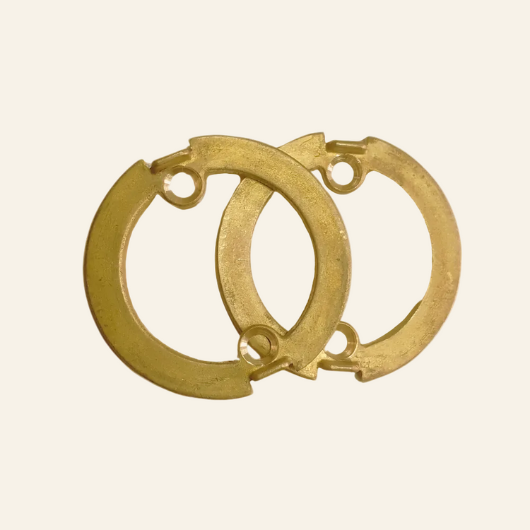 A pair of gold-colored brass rings designed for use with a lever handle.