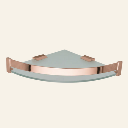 A triangular corner wall shelf made of frosted light gray glass with a polished rose gold metal frame and brackets, shown against a plain white background.