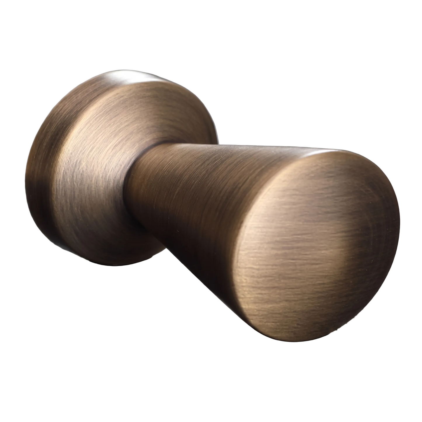 A close-up of a round cabinet knob with a brushed antique bronze finish, resting on a dark textured slate surface.