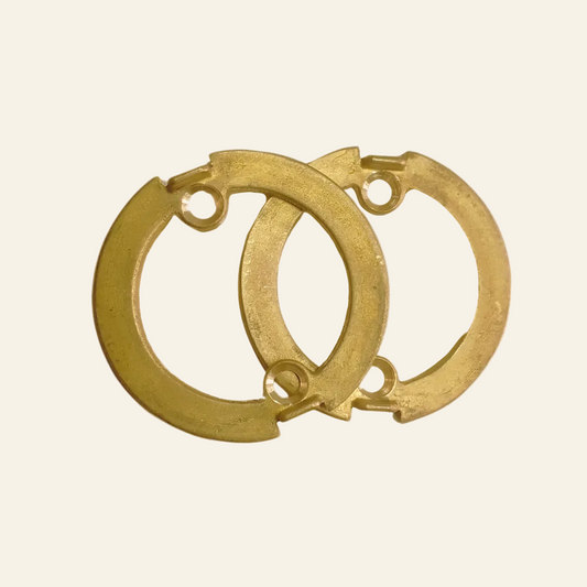 A pair of gold-colored brass rings designed for use with a lever handle.