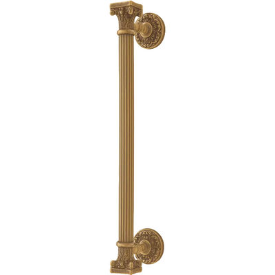 An ornate vertical cabinet pull handle with a fluted column design and decorative round mounts, shown in a warm antique gold/brass finish against a plain light beige background.