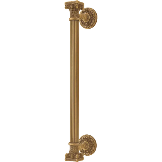 An ornate vertical cabinet pull handle with a fluted column design and decorative round mounts, shown in a warm antique gold/brass finish against a plain light beige background.