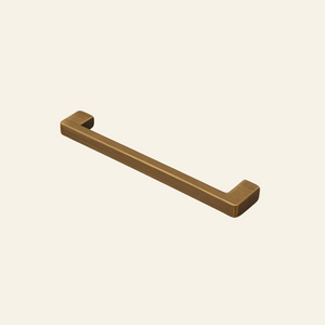 Bronze cabinet handle on a light gray background