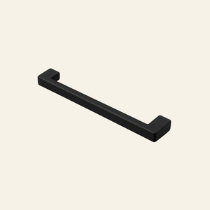 Black cabinet handle on a light gray background