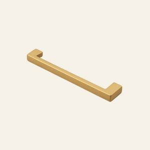Bronze cabinet handle on a light gray background