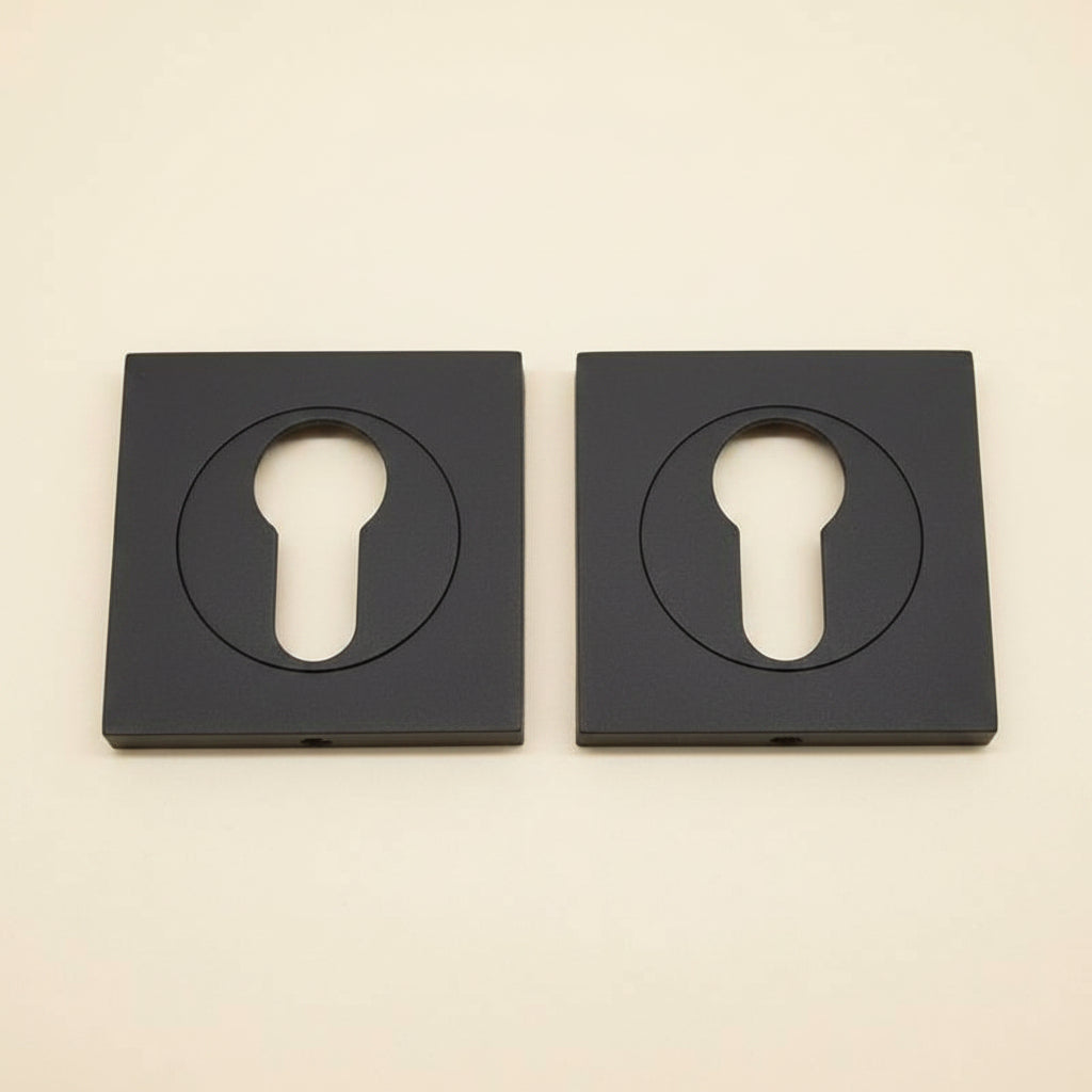 Two black solid brass square key plates with a powder coated finish, displayed on a white background.