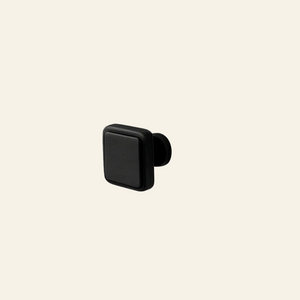 Black Orbex furniture knob on a white cabinet with Aceline branding.