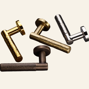 AceLine Max Series Set of metallic door handles in gold, bronze, and silver on a dark background