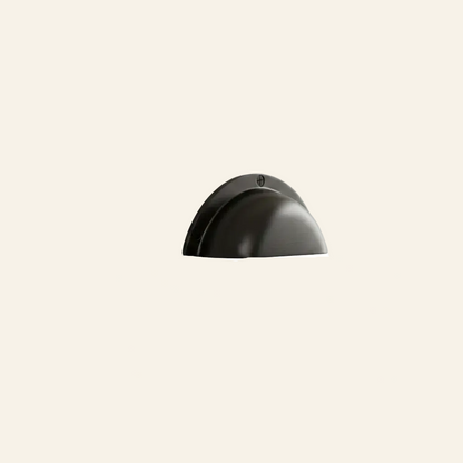 Black cabinet handle on a light gray cabinet