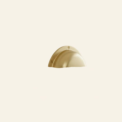 Gold cabinet handle on a light gray cabinet