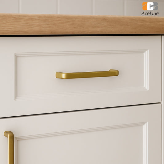 Close-up of a kitchen cabinet with white doors and gold handles, featuring the AceLine logo.