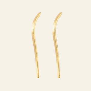 A pair of gold-toned, curved bar earrings shown against a plain white background.